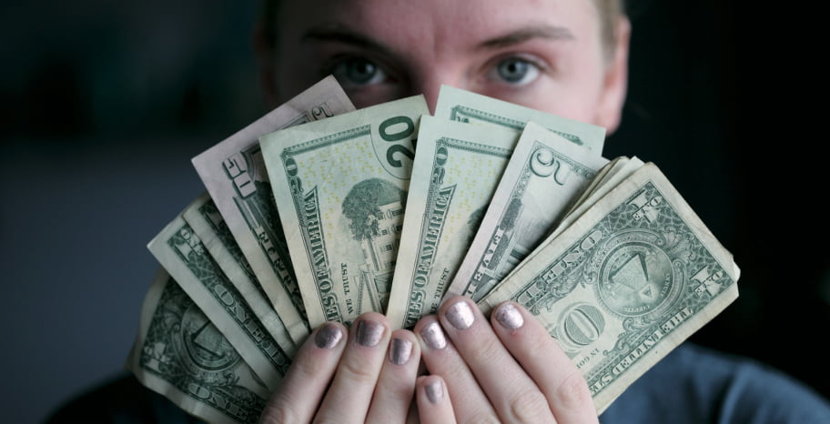 Woman holding dollar bills	